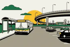 City bus at a shelter by a park-and-ride lot
